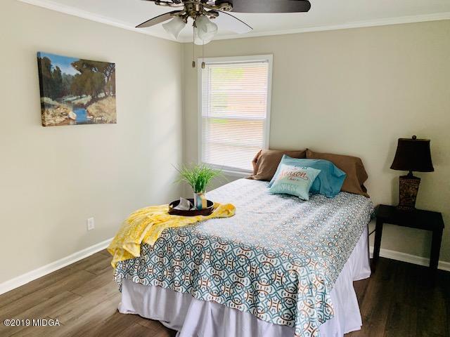 6609 Vinson Road Macon, GA 31216 - Photo 17 of 22 a bedroom with a bed and wooden floor