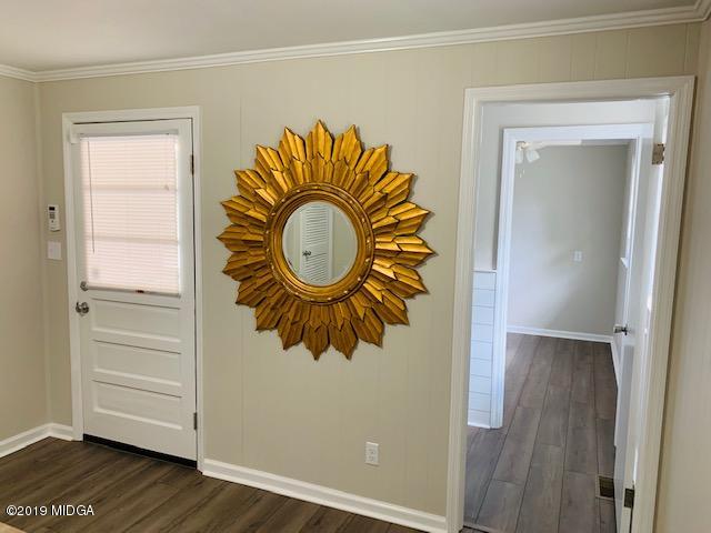 6609 Vinson Road Macon, GA 31216 - Photo 18 of 22 a view of walk in closet with wooden floor