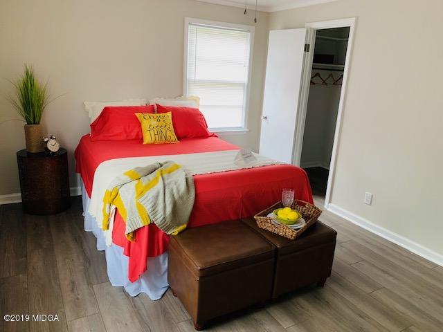 6609 Vinson Road Macon, GA 31216 - Photo 20 of 22 a bedroom with a bed and wooden floor