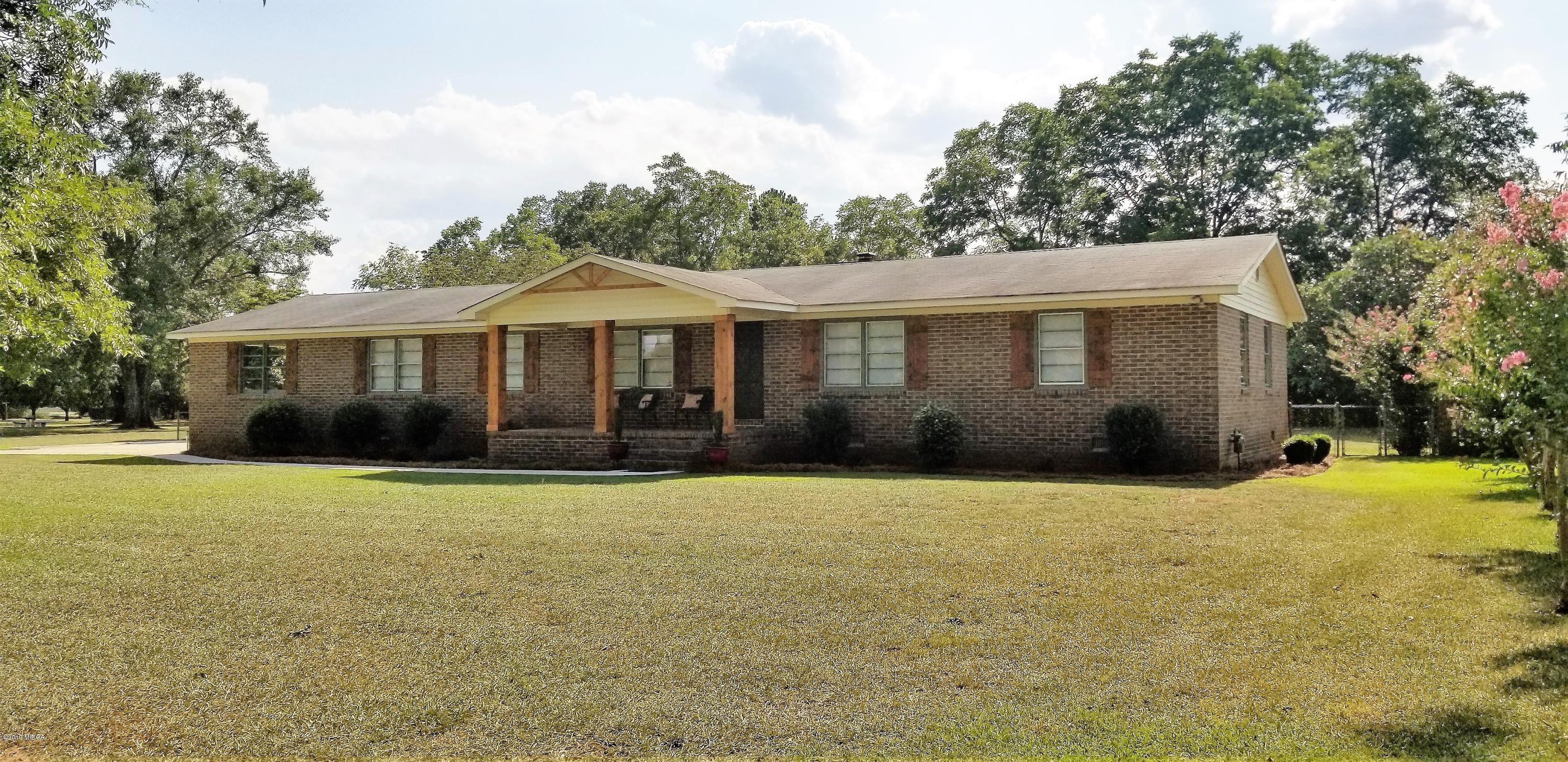 6609 Vinson Road Macon, GA 31216 - Photo 3 of 22 a front view of a house with yard and garage