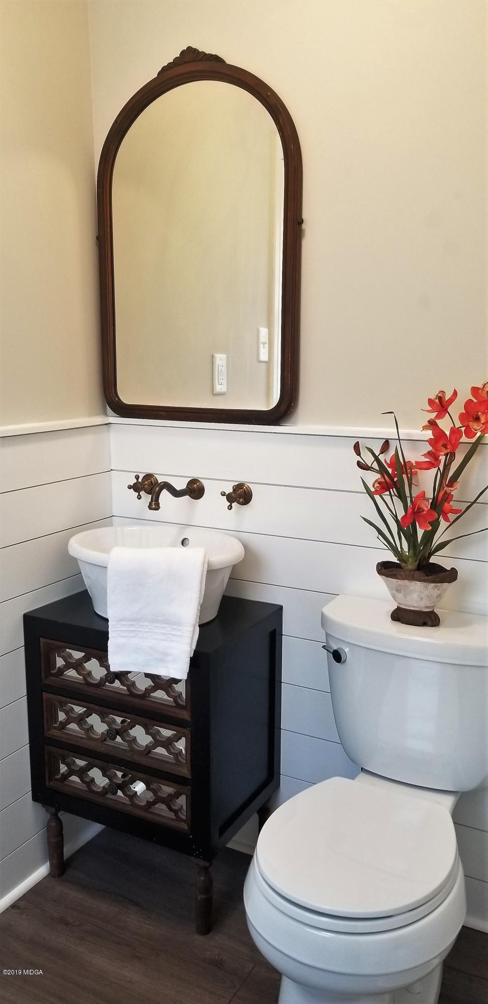 6609 Vinson Road Macon, GA 31216 - Photo 5 of 22 a bathroom with a toilet a sink and a mirror