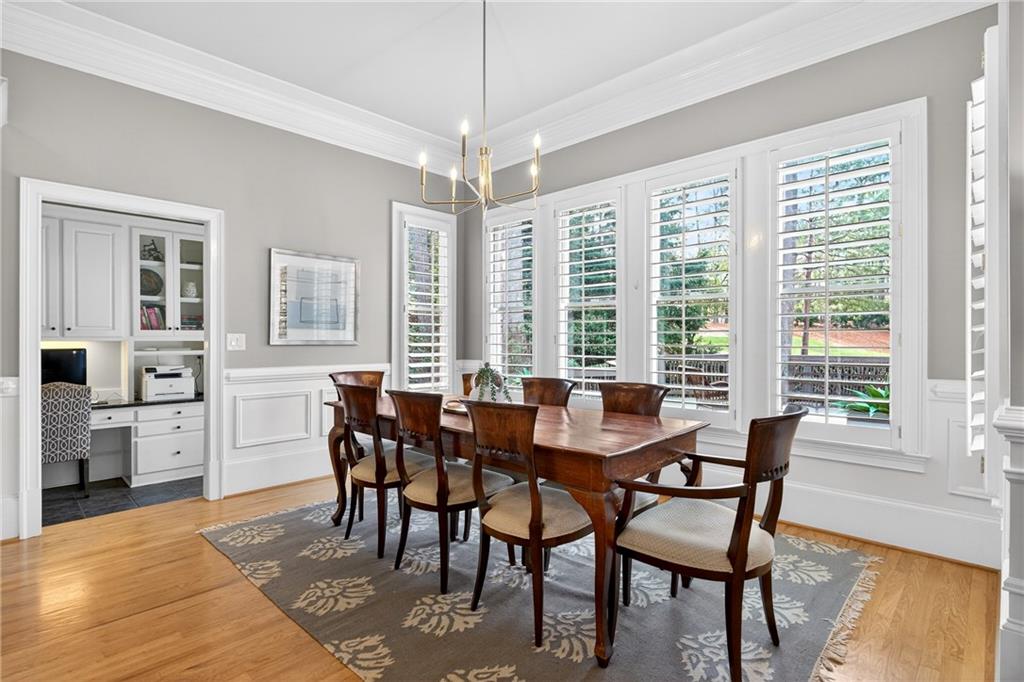 5040 Harrington Road Alpharetta, GA 30022 - Photo 15 of 54 a view of a dining room with furniture and wooden floor