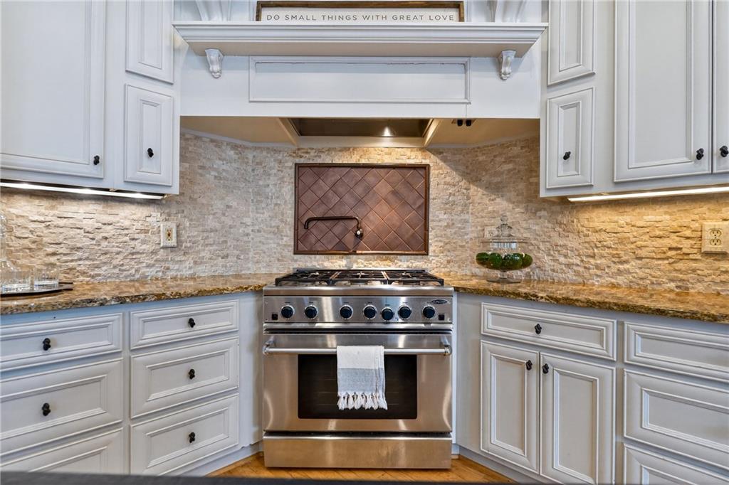 5040 Harrington Road Alpharetta, GA 30022 - Photo 17 of 54 a stove top oven sitting inside of a kitchen