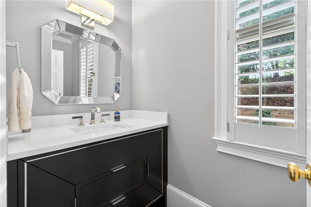 5040 Harrington Road Alpharetta, GA 30022 - Photo 19 of 54 a bathroom with a sink vanity and a mirror