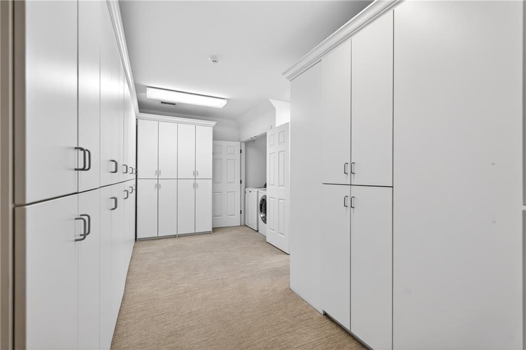 5040 Harrington Road Alpharetta, GA 30022 - Photo 25 of 54 a view of a hallway with wooden cabinets