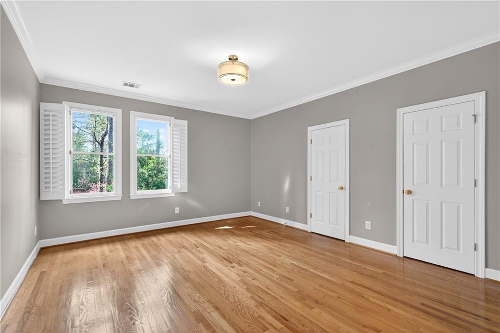 5040 Harrington Road Alpharetta, GA 30022 - Photo 31 of 54 a view of an empty room with wooden floor and a window