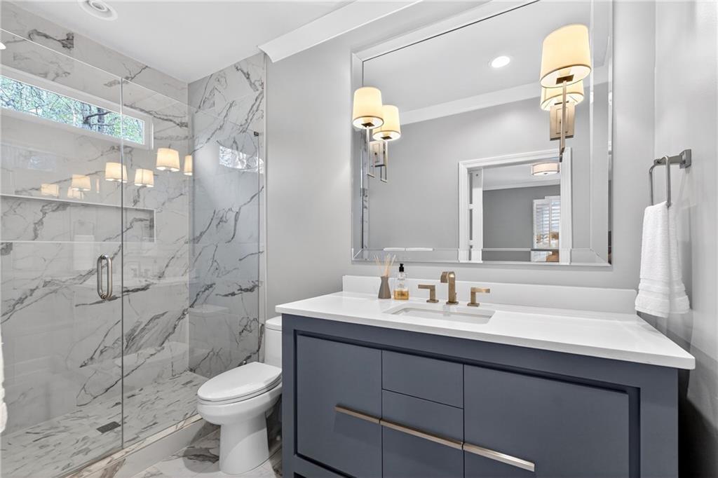 5040 Harrington Road Alpharetta, GA 30022 - Photo 33 of 54 a bathroom with a sink toilet and shower