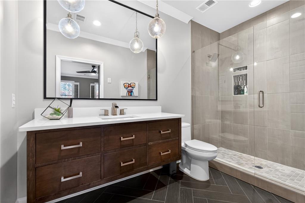 5040 Harrington Road Alpharetta, GA 30022 - Photo 37 of 54 a bathroom with a double vanity sink mirror and toilet