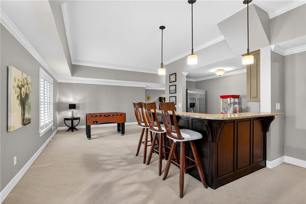 5040 Harrington Road Alpharetta, GA 30022 - Photo 40 of 54 a dining room with furniture and a chandelier
