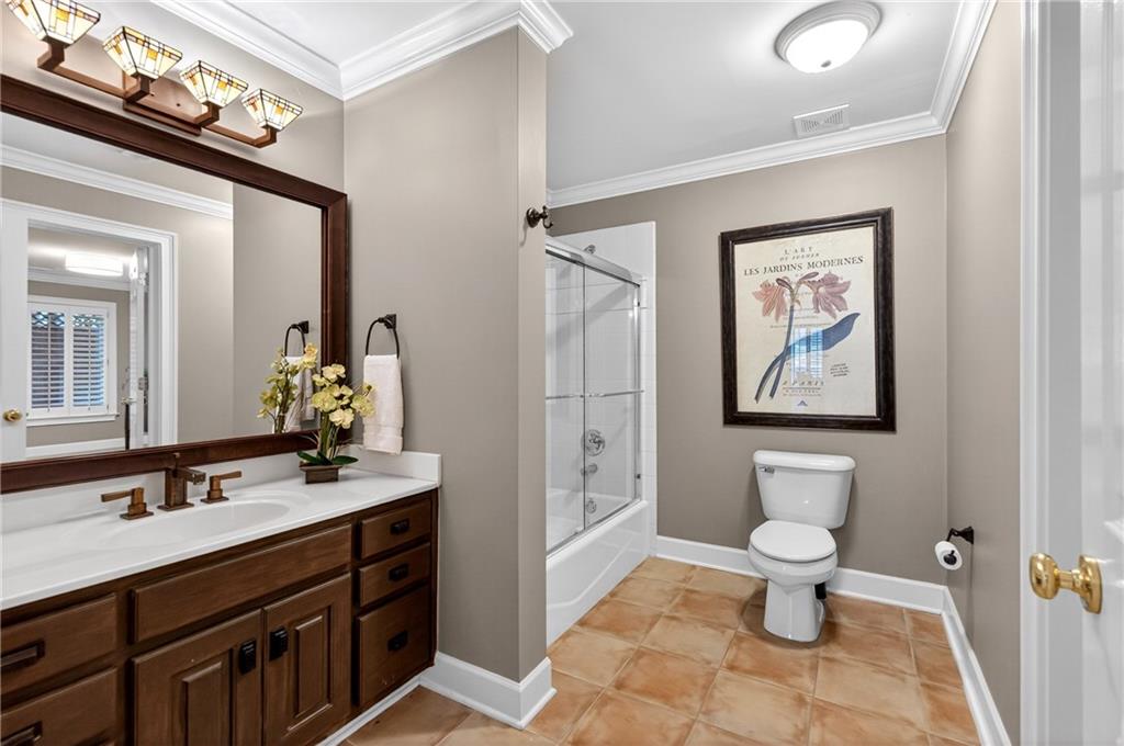5040 Harrington Road Alpharetta, GA 30022 - Photo 44 of 54 a bathroom with a toilet sink and mirror