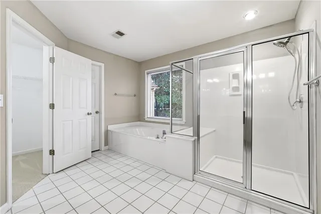 a spacious bathroom with a bathtub and a shower