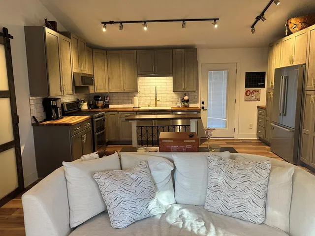 a kitchen with a sink stove and refrigerator