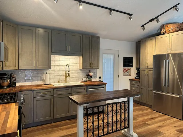 a kitchen with a sink stove and refrigerator
