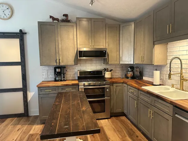 a kitchen with granite countertop a stove and a sink
