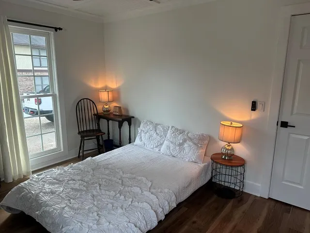 a bedroom with a bed and a desk
