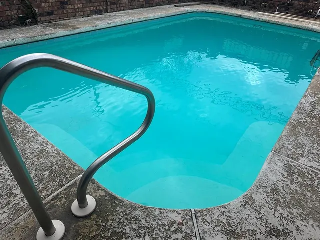 a living room with furniture a fireplace and wall paintings