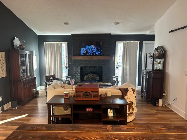 a living room with furniture and a fireplace
