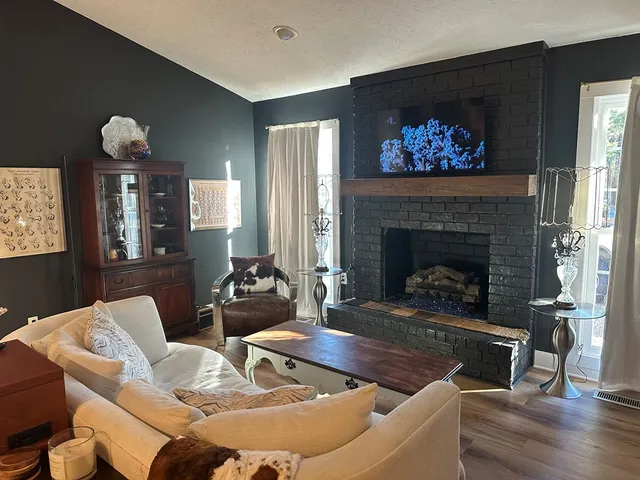 a living room with furniture and a fireplace
