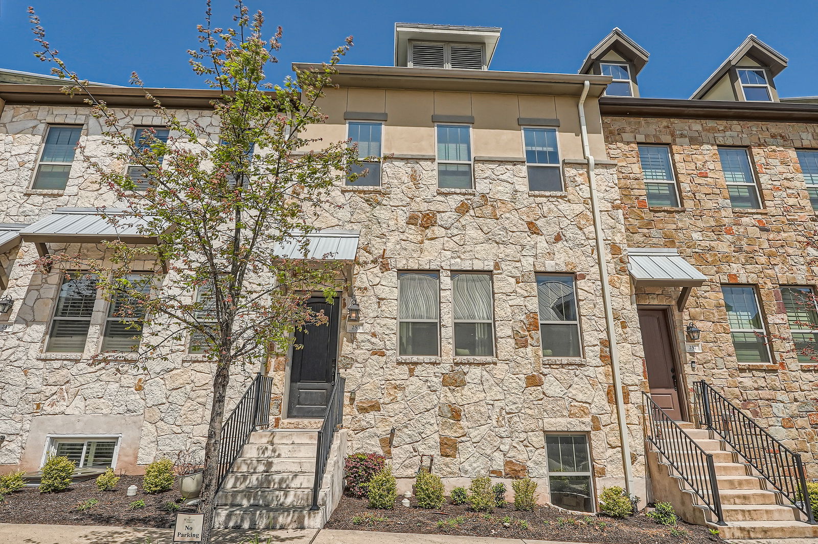 View of property featuring stucco siding and stone siding