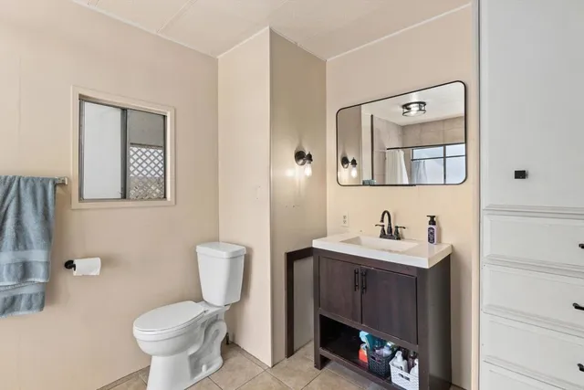 a bathroom with a toilet a sink and mirror