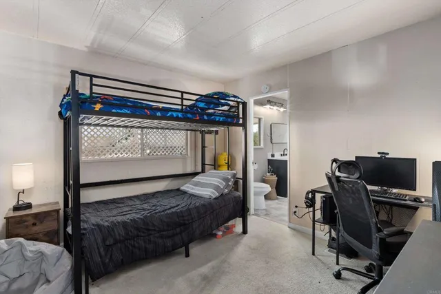 a bedroom with a bed and a desk
