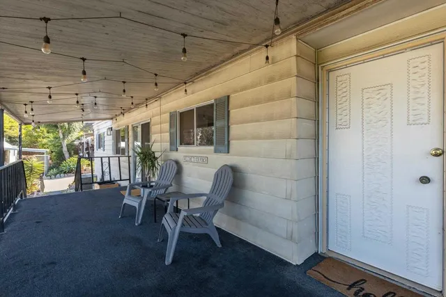a dining room with furniture and a floor to ceiling window