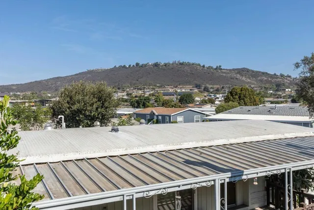 a view of a balcony with wooden floor and fence