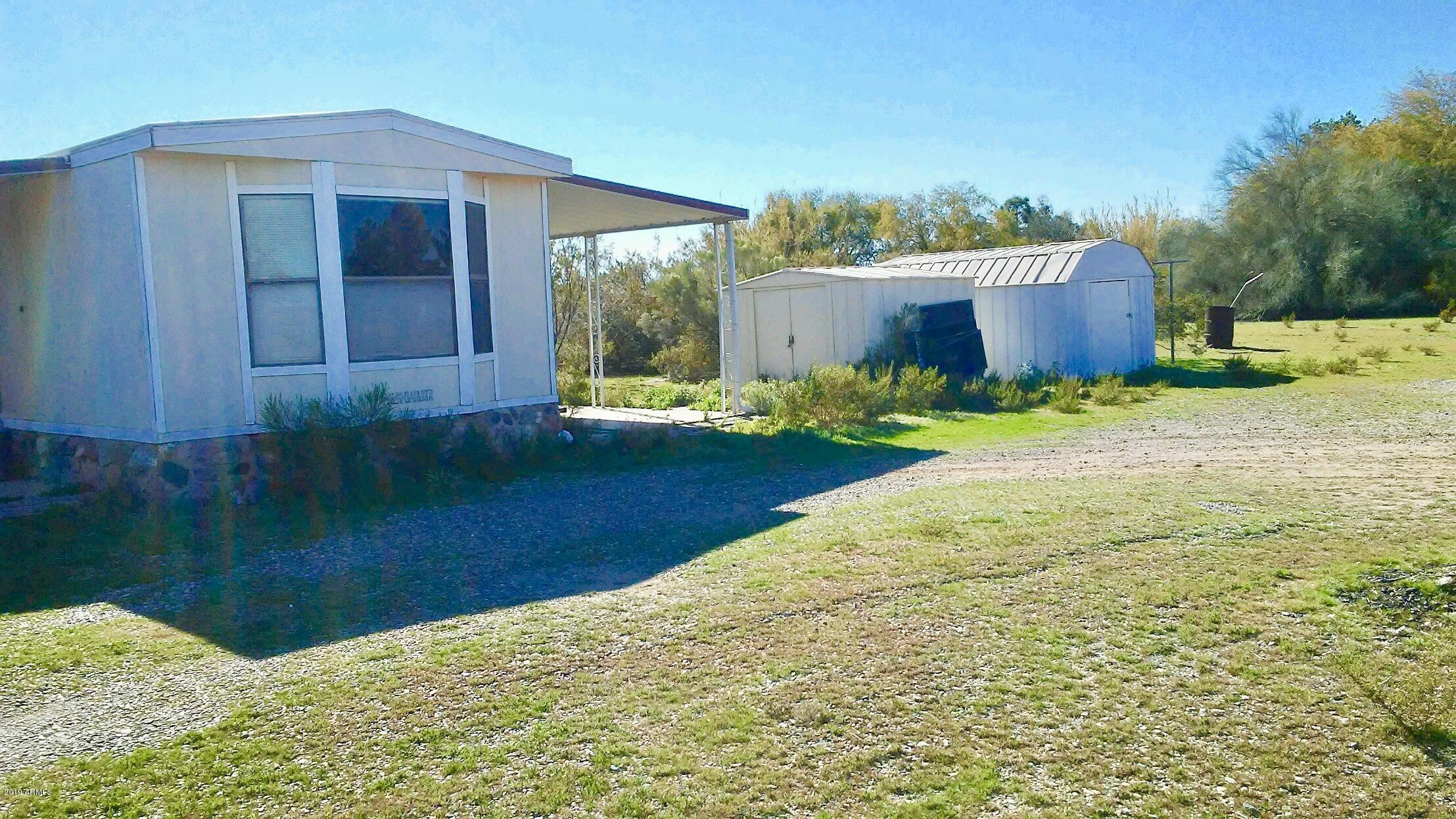21022 West Silver Bell Road Wittmann, AZ 85361 - Photo 3 of 16 Side view with 2 storage sheds.