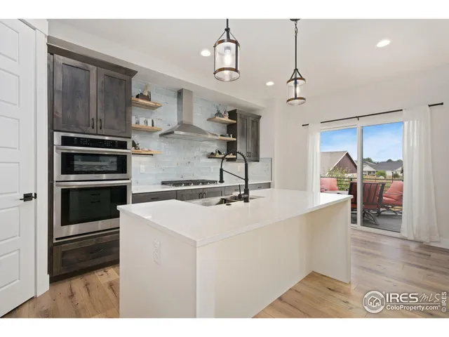 a kitchen with kitchen island a sink stainless steel appliances and cabinets