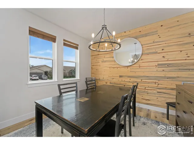 a dining room with a table and chairs