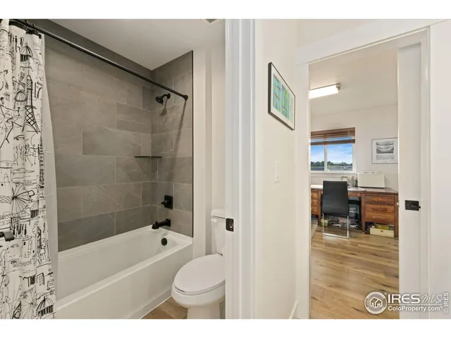 a bathroom with a sink double vanity granite and a shower