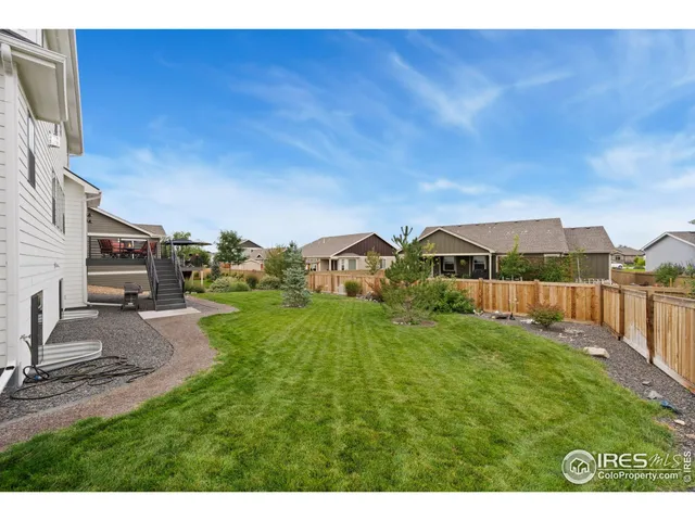 an aerial view of residential house with outdoor space and mountain view in back