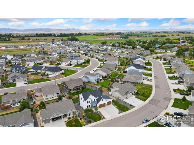 an aerial view of residential houses with outdoor space and trees