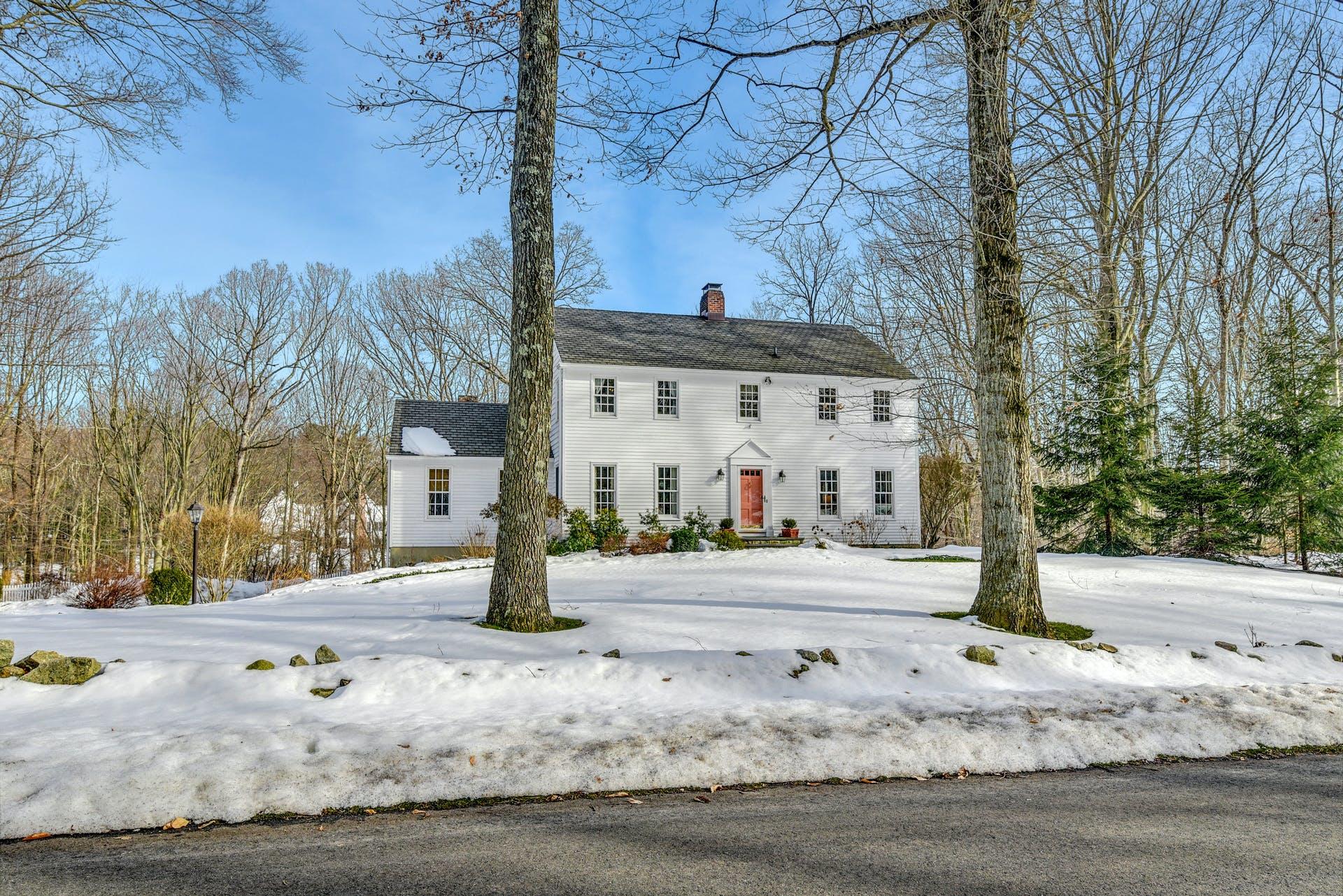 258 Jonathan Road New Canaan, CT 06840 - Photo 1 of 33 a front view of a building with street
