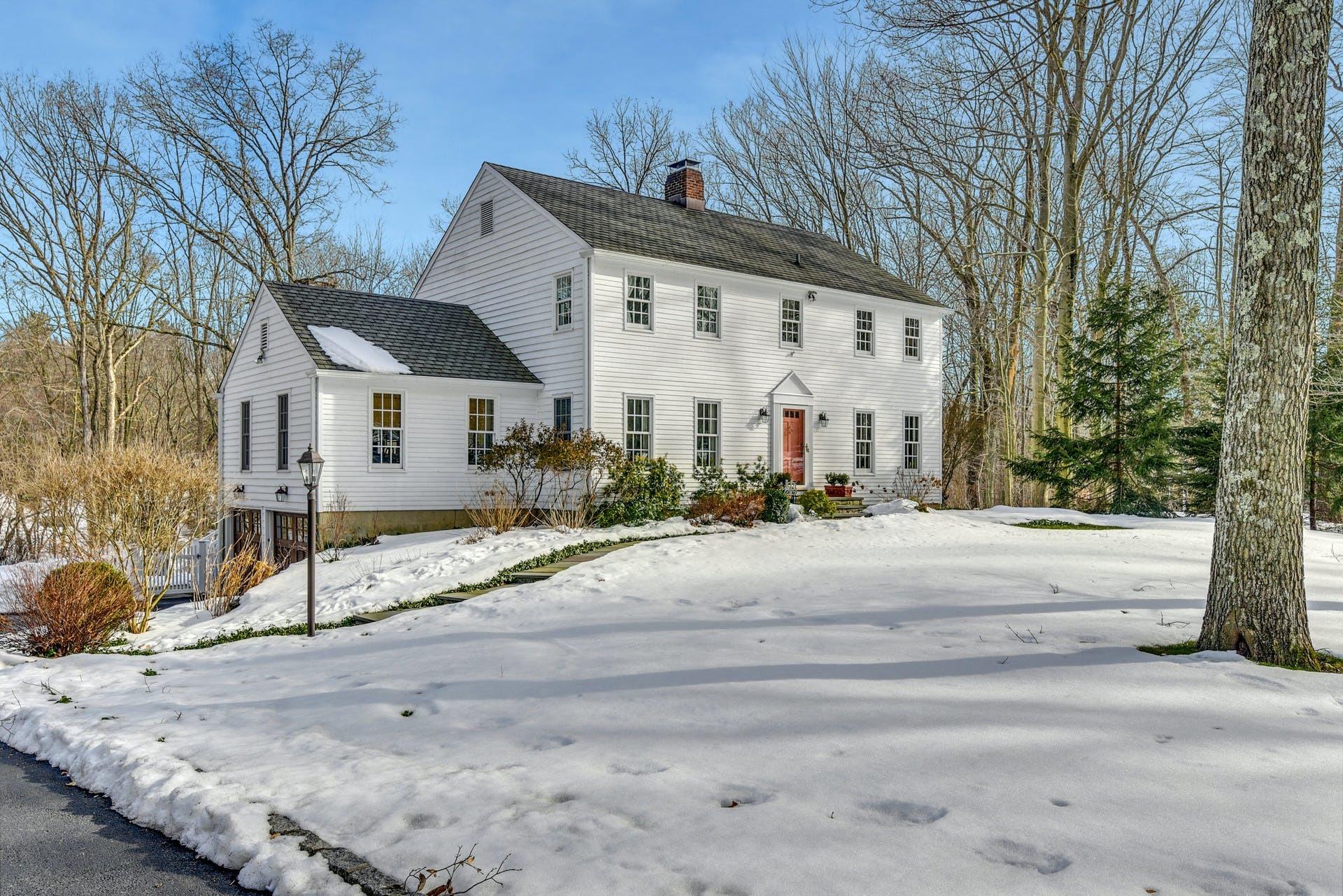 258 Jonathan Road New Canaan, CT 06840 - Photo 2 of 33 a front view of a house with a yard