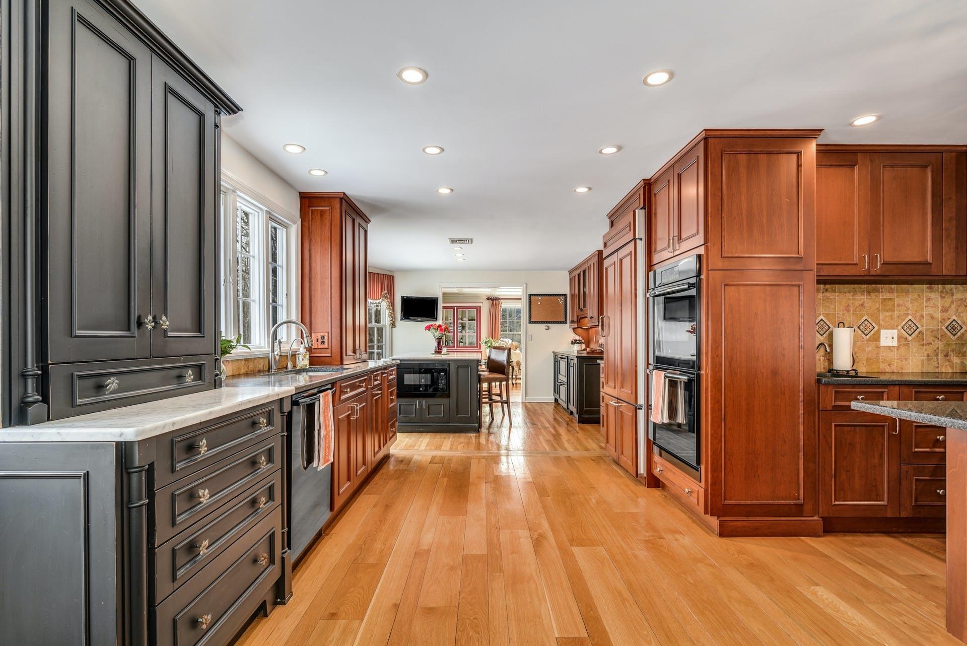 258 Jonathan Road New Canaan, CT 06840 - Photo 13 of 33 a open kitchen with stainless steel appliances granite countertop a refrigerator a sink dishwasher a stove and white cabinets with wooden floor