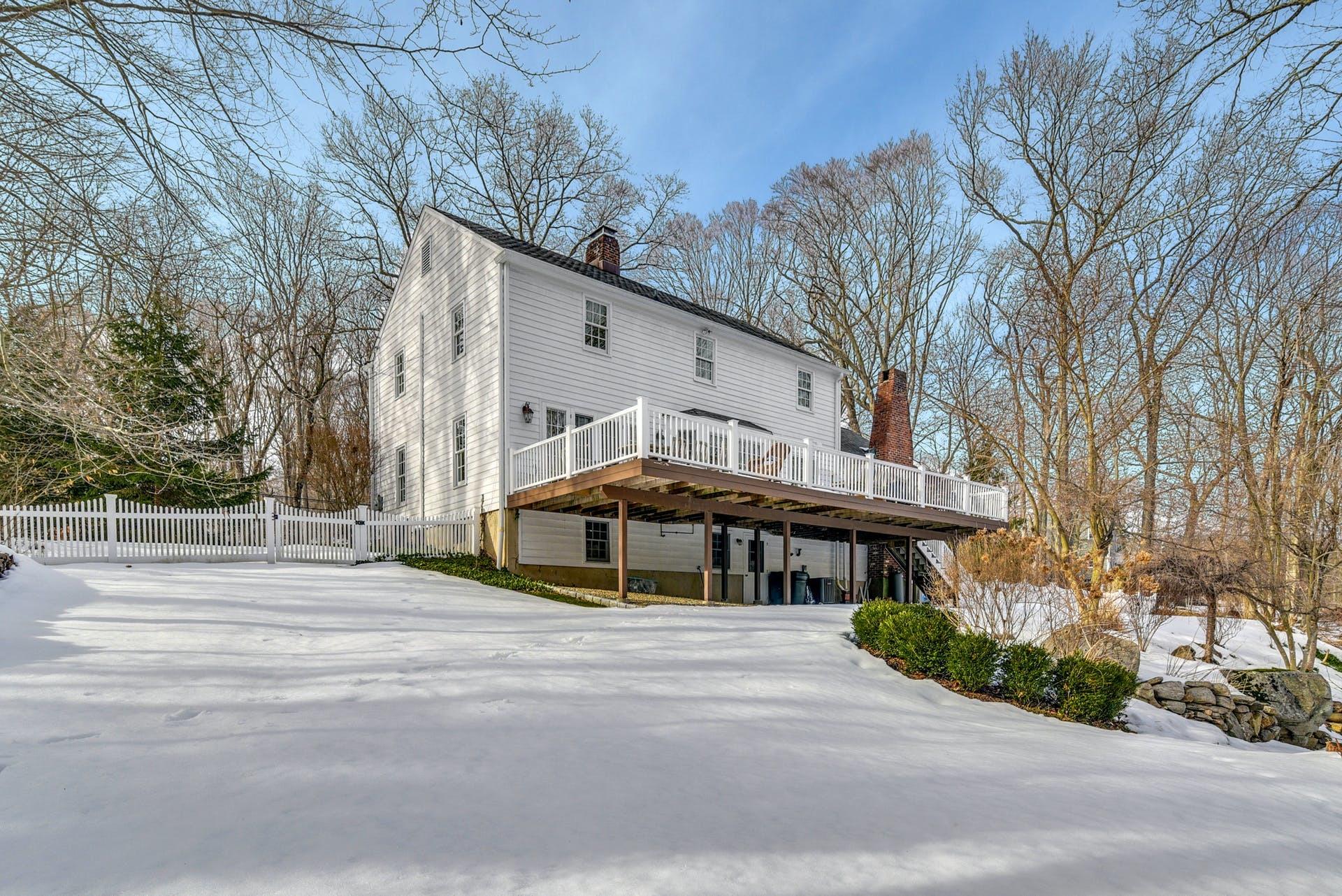 258 Jonathan Road New Canaan, CT 06840 - Photo 29 of 33 a front view of a house with a yard
