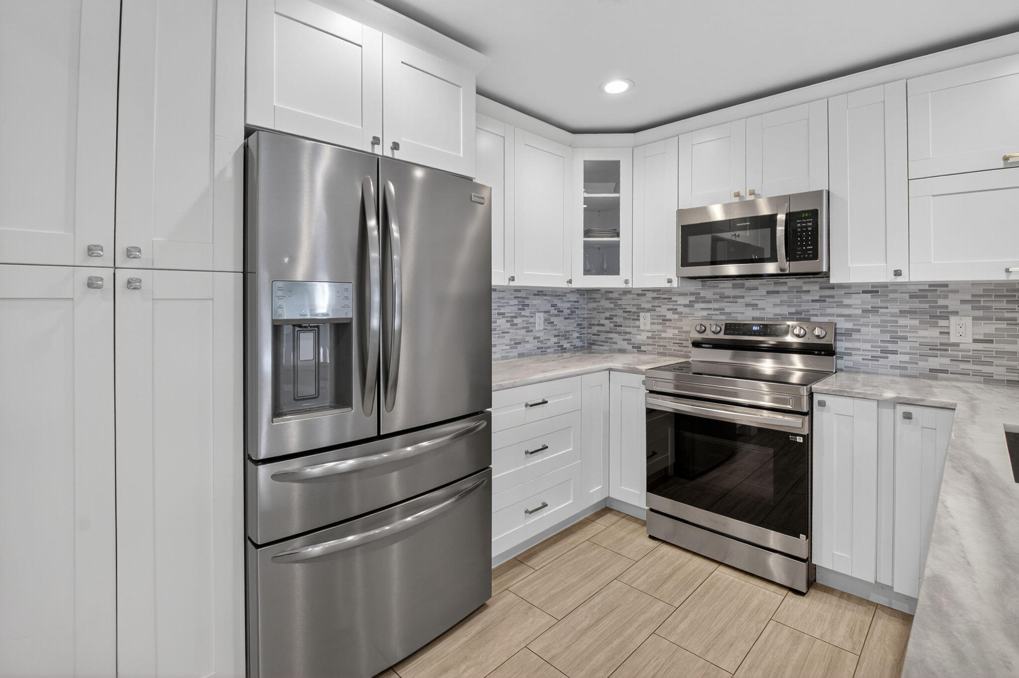 2226 Northwest 52nd Street Boca Raton, FL 33496 - Photo 16 of 49 a kitchen with stainless steel appliances granite countertop a refrigerator stove and microwave