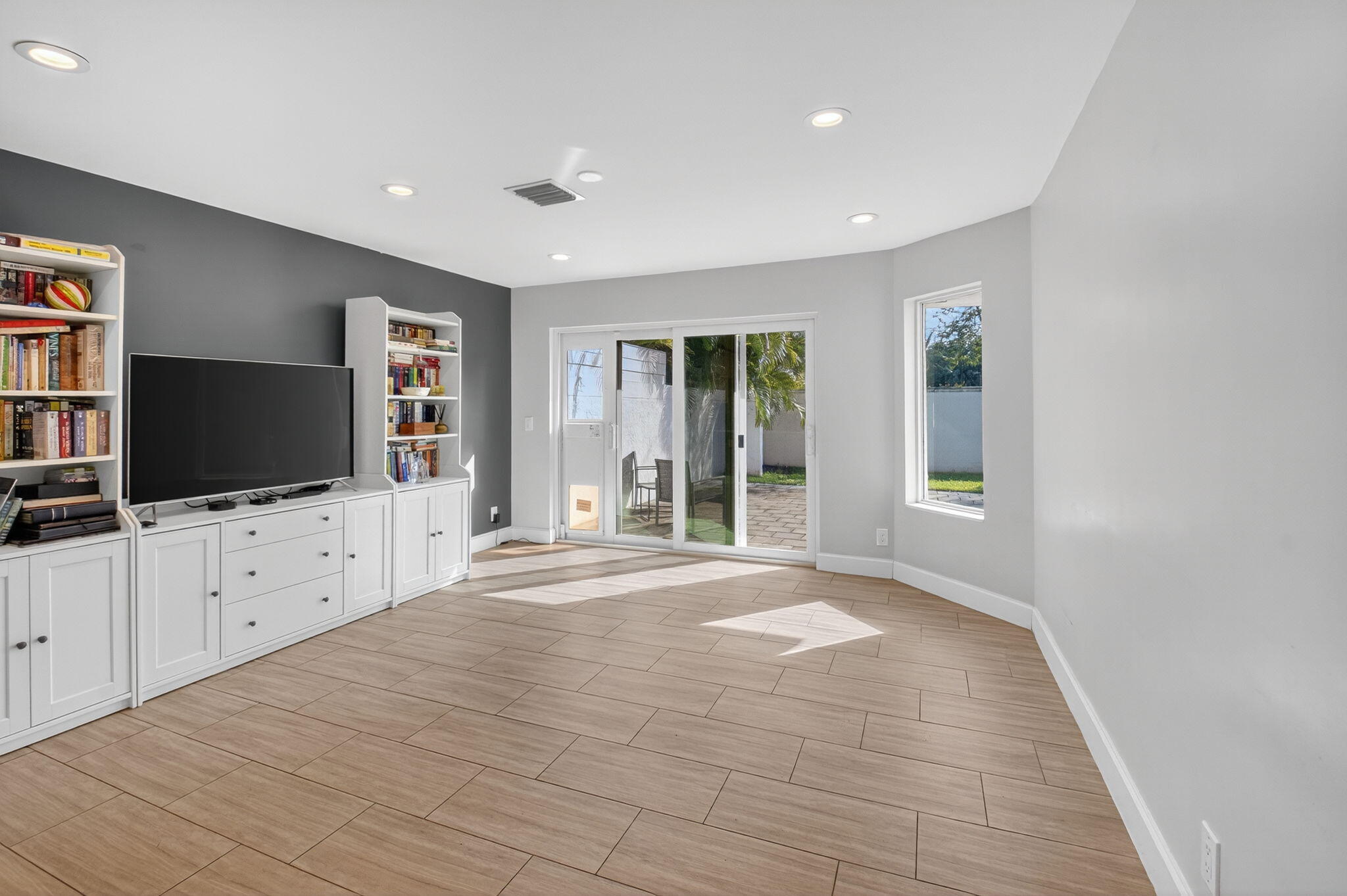 2226 Northwest 52nd Street Boca Raton, FL 33496 - Photo 21 of 49 a view of a livingroom with wooden floor and windows