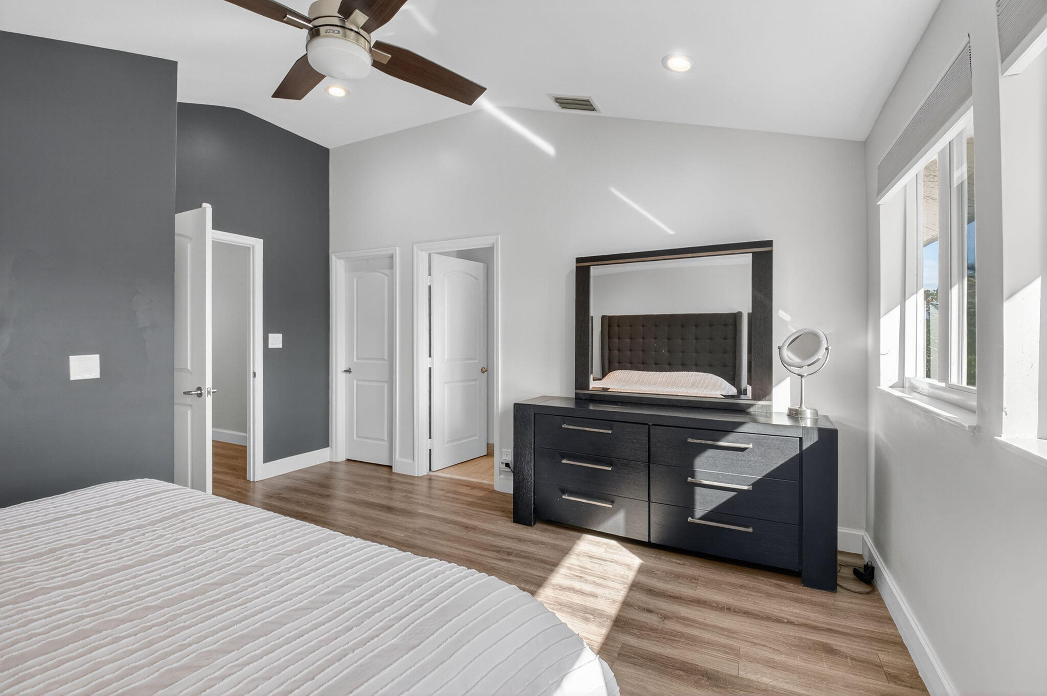 2226 Northwest 52nd Street Boca Raton, FL 33496 - Photo 24 of 49 a bedroom with a bed and a chandelier