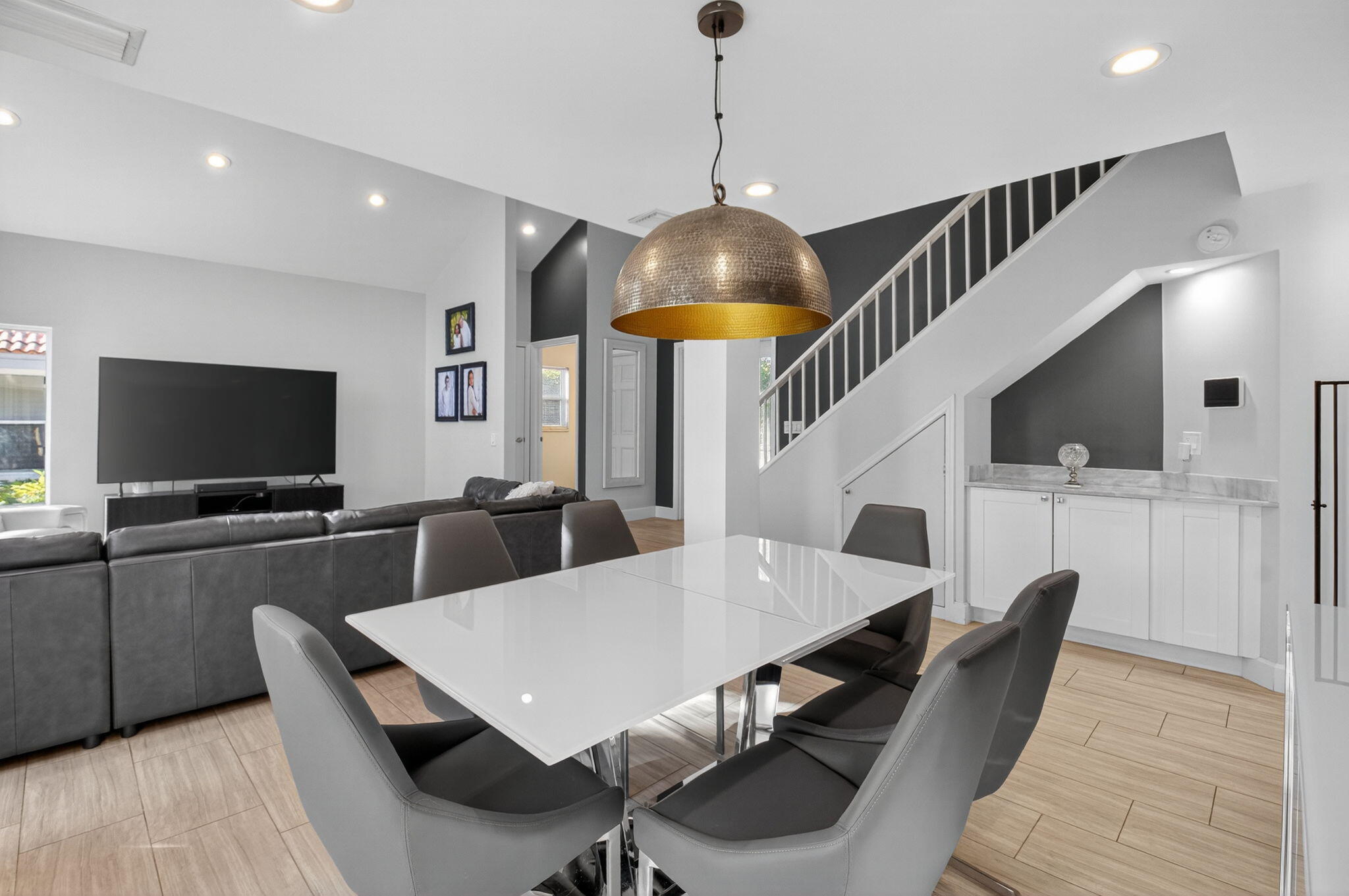 2226 Northwest 52nd Street Boca Raton, FL 33496 - Photo 10 of 49 a dinning room with furniture a rug and a flat screen tv