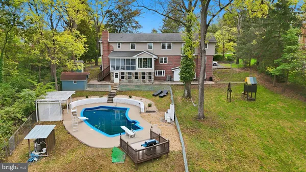 a front view of a house with swimming pool garden and patio