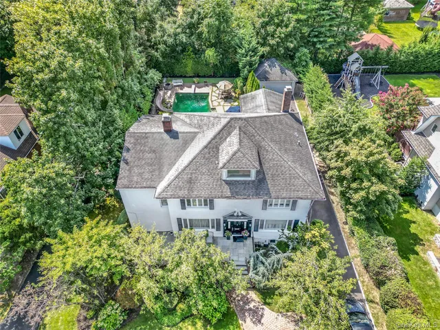 an aerial view of a house with a garden and plants