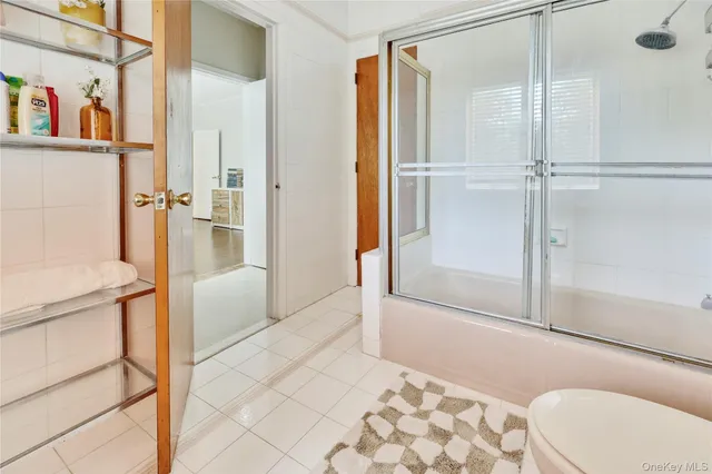 a bathroom with a toilet sink and shower