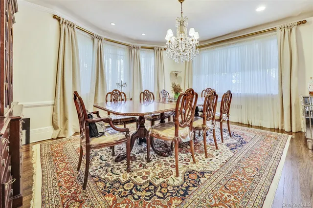 a view of a dining room with furniture and chandelier