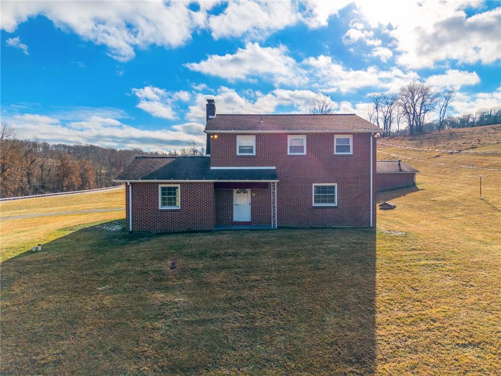 905 Watt Road Apollo, PA 15613 - Photo 25 of 30 a view of a brick house next to a yard with an ocean view