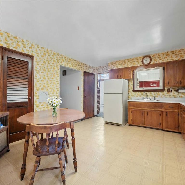 905 Watt Road Apollo, PA 15613 - Photo 10 of 30 a kitchen with stainless steel appliances a table and chairs in it