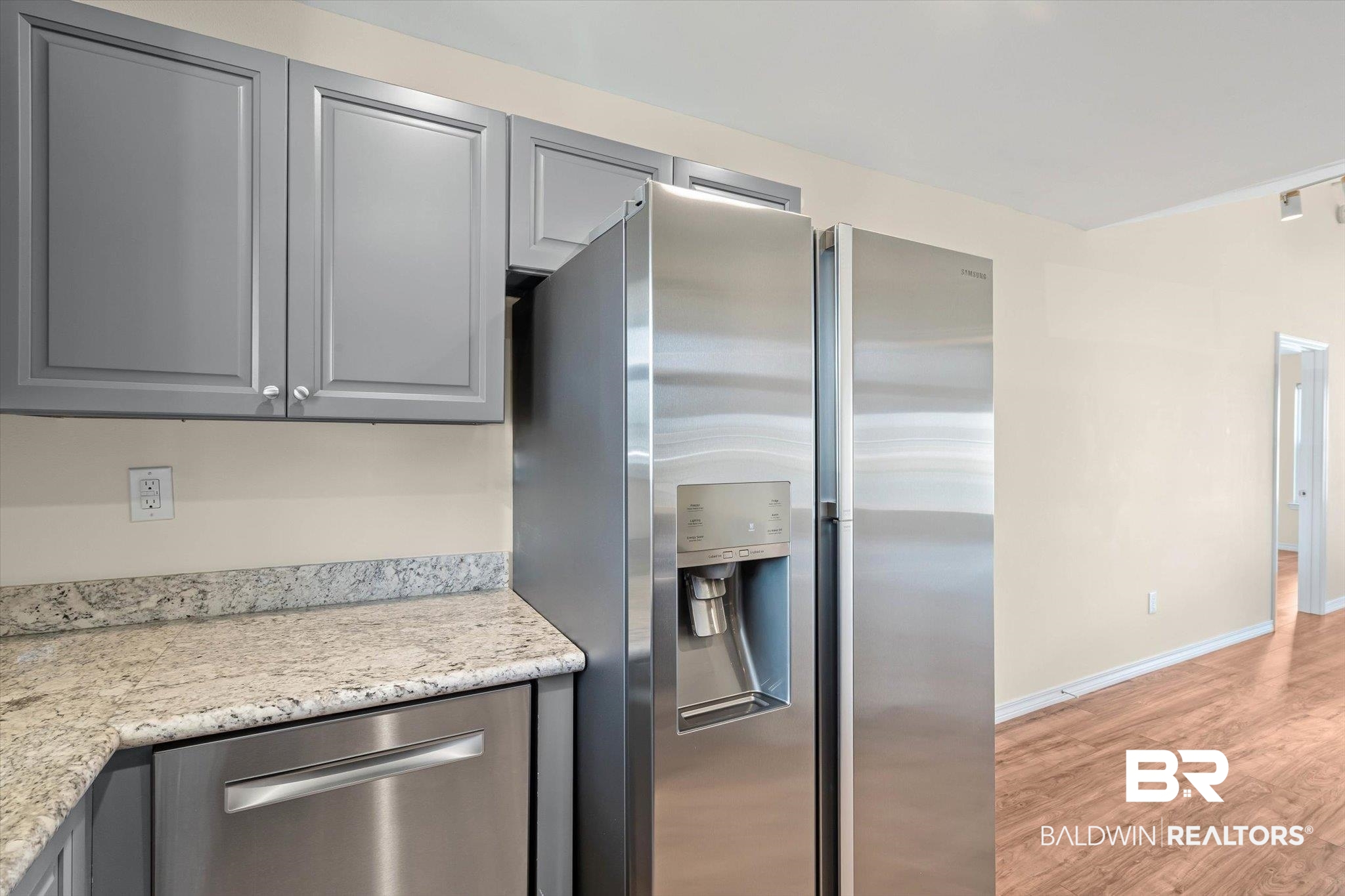 919 Sailor Circle Foley, AL 36535 - Photo 9 of 24 Kitchen with stainless steel appliances, gray cabinets, light wood-type flooring, and light stone countertops