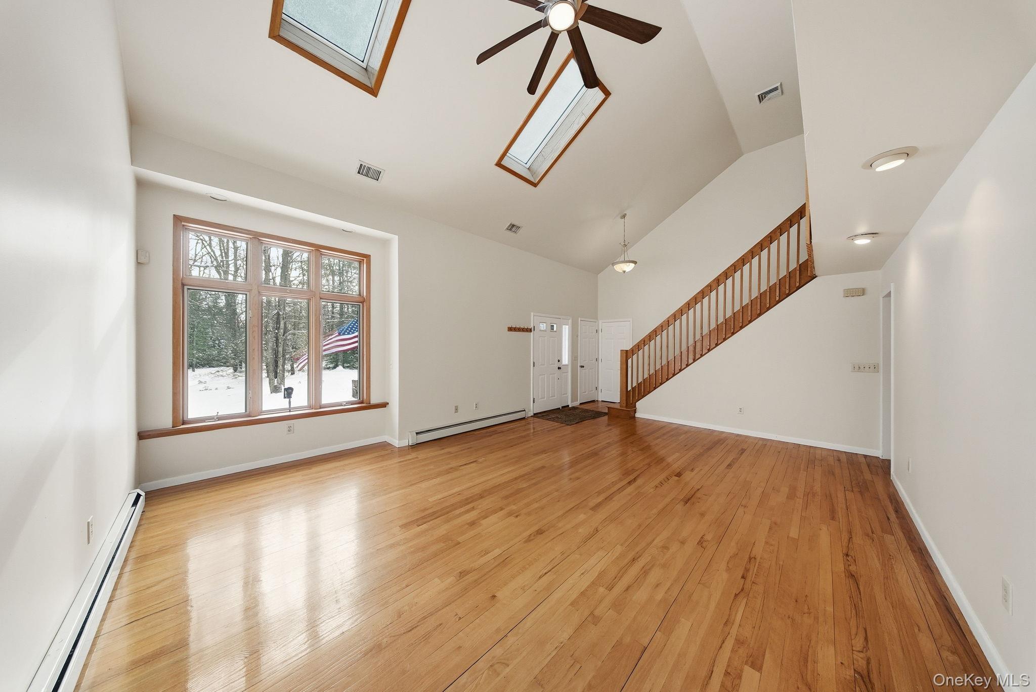 139 Renner Road Mountain Dale, NY 12763 - Photo 6 of 50 a view of an empty room with wooden floor and a window