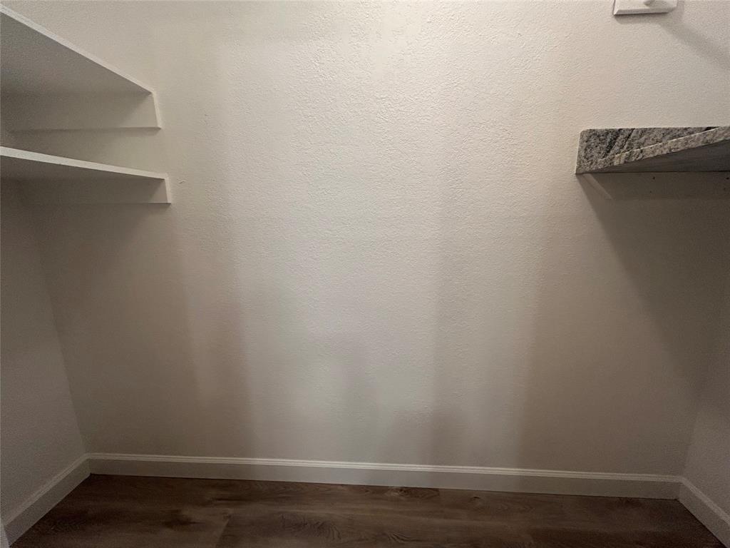 415 Rifleman Trail Arlington, TX 76002 - Photo 22 of 22 Utility room with shelves that go above the washer and dryer.